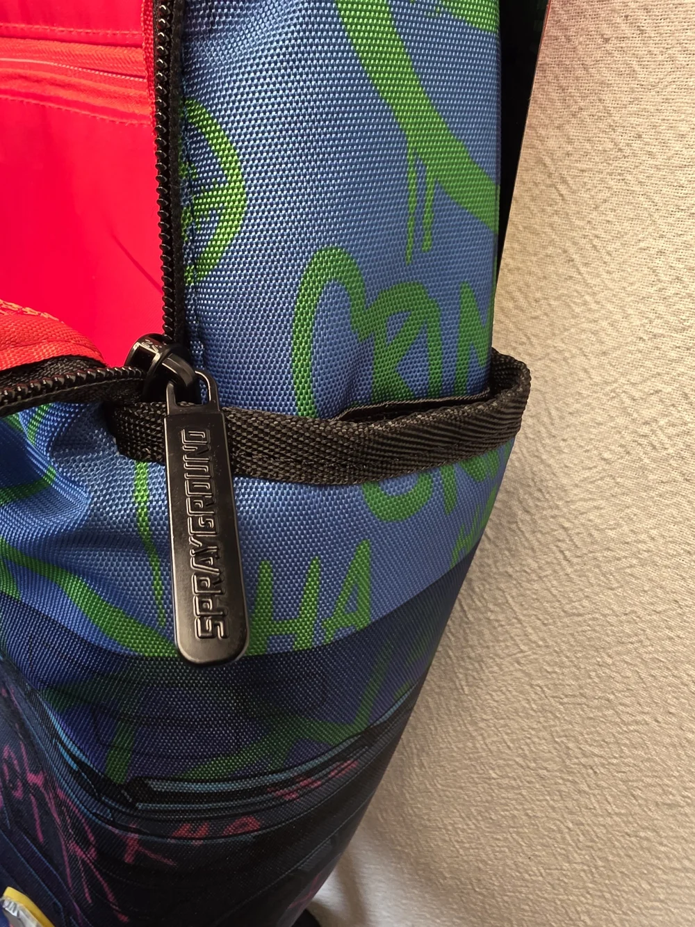 Sprayground DC Joker No Rules Backpack featuring a vibrant, graffiti-styled Bag
